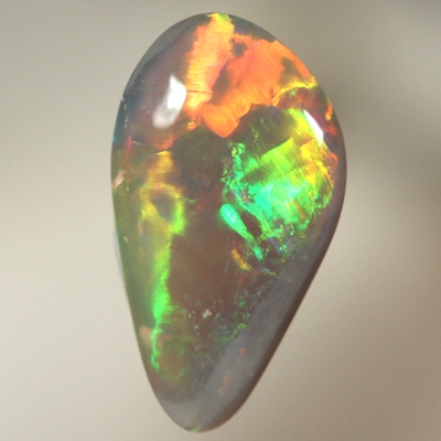 SOLID SEMI BLACK OPAL Large rolling flashes of bright multicolours